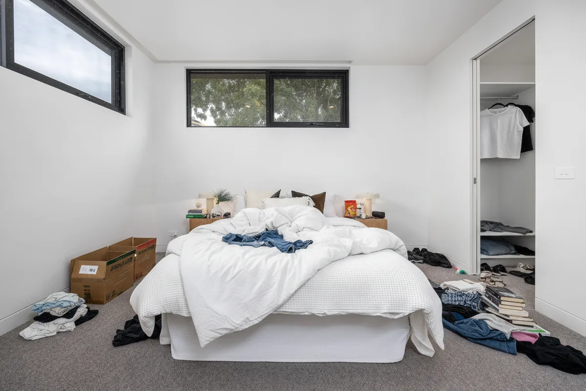 A cluttered, lived-in bedroom